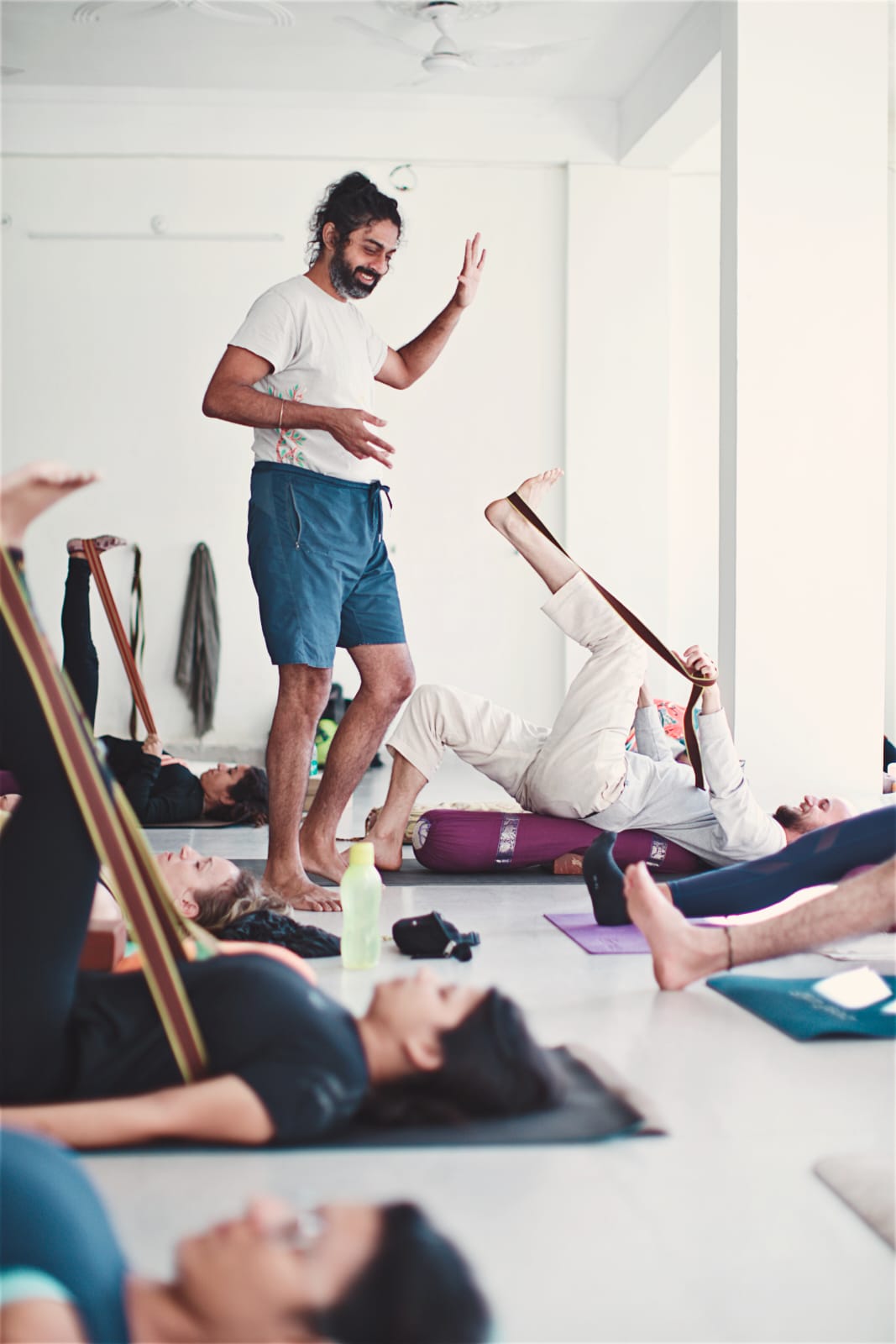 Props-supported therapeutic yoga in a sunlit hall